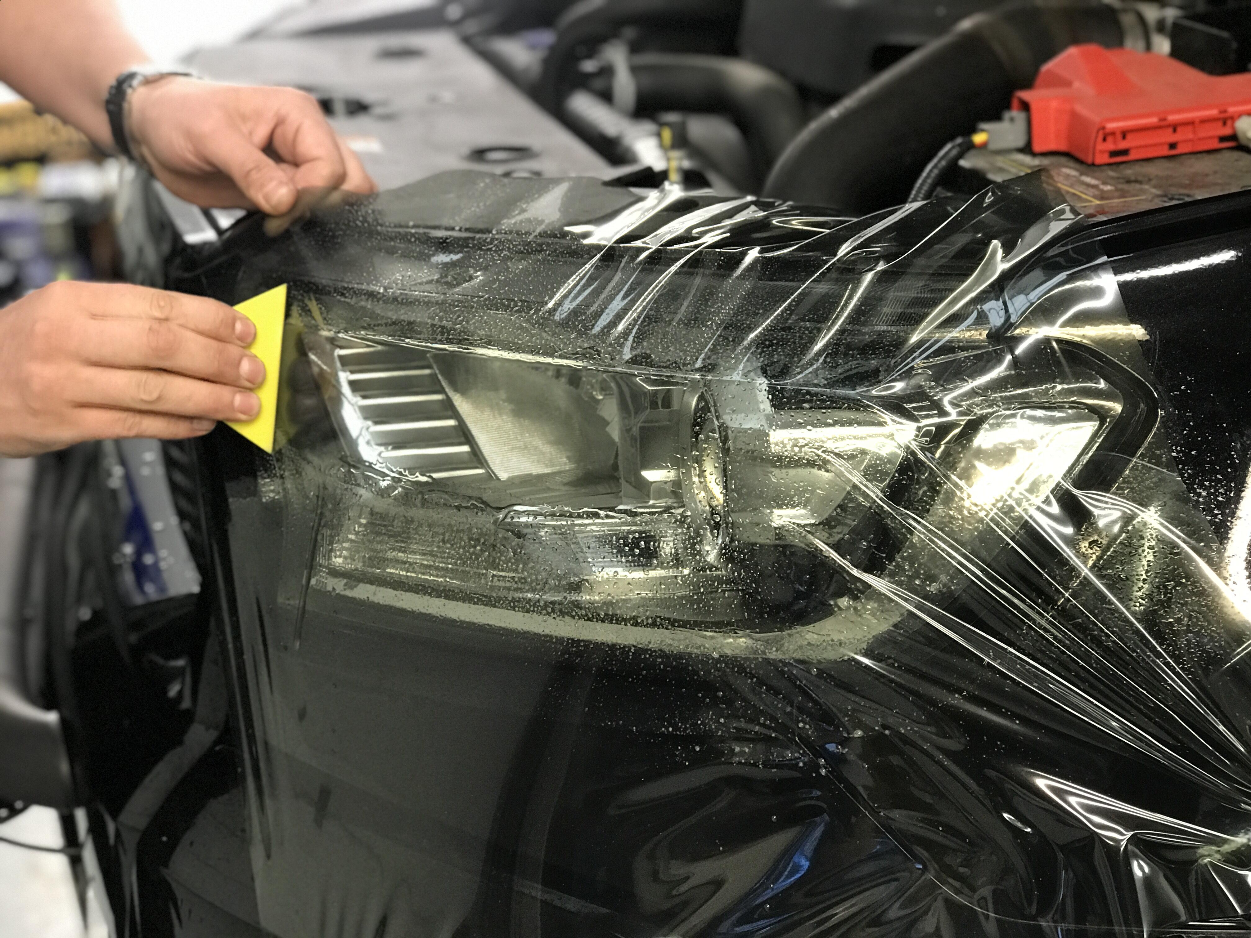 front headlight tint being professionally fitted
