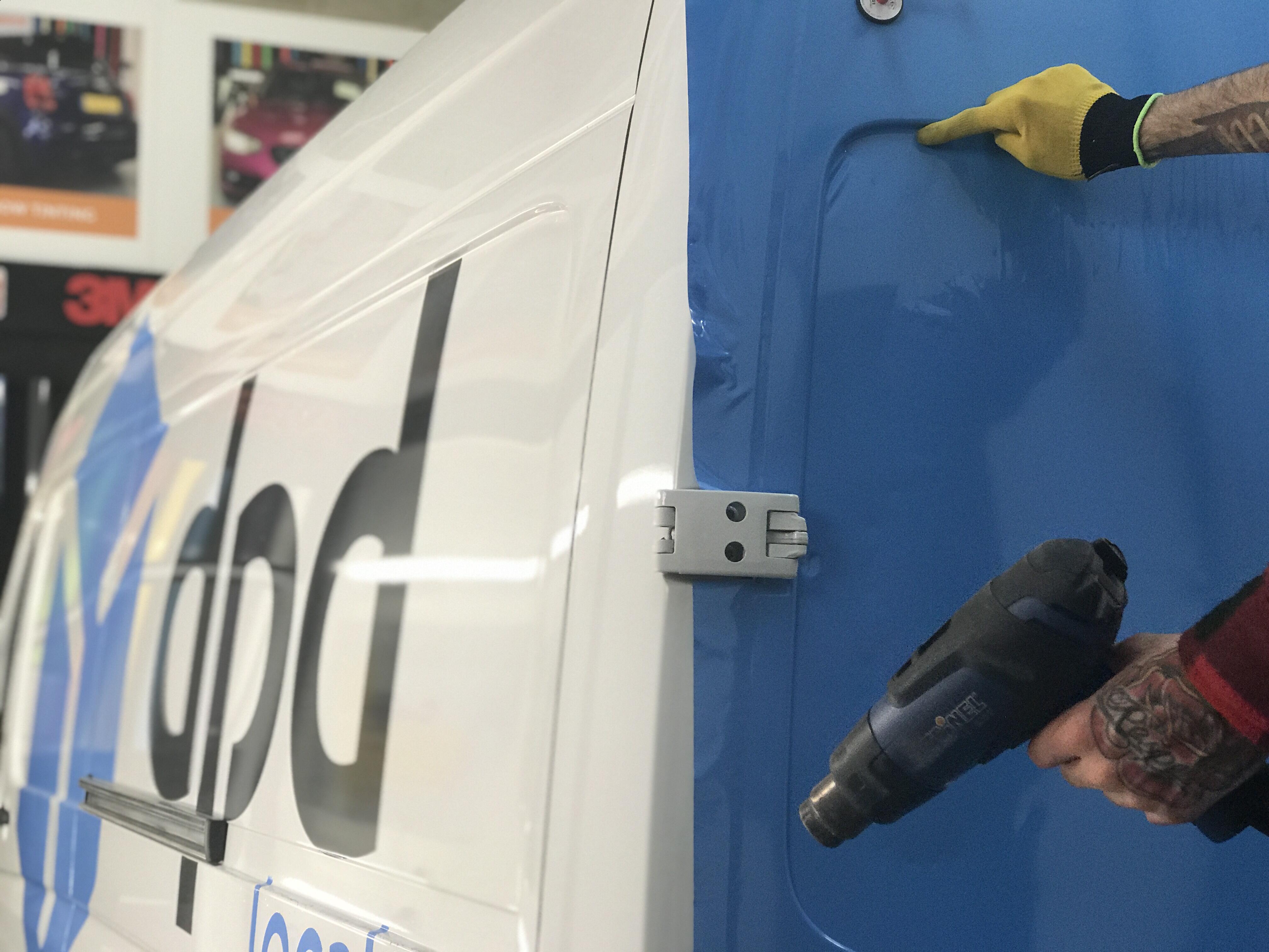 installation of rear door wrap on fleet vehicle
